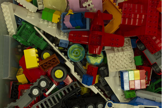 A bin filled with colorful building blocks and Montessori toys to encourage creative play and logical thinking.
