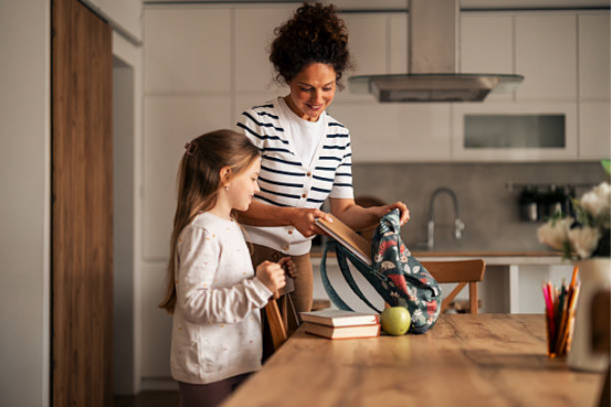 The little girl went to the kitchen to play with her Montessori toys after school.
