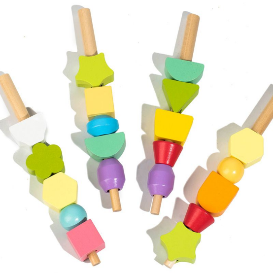 Close-up of stacked colorful geometric wooden Montessori toys on rods, perfect for early shape and color learning.