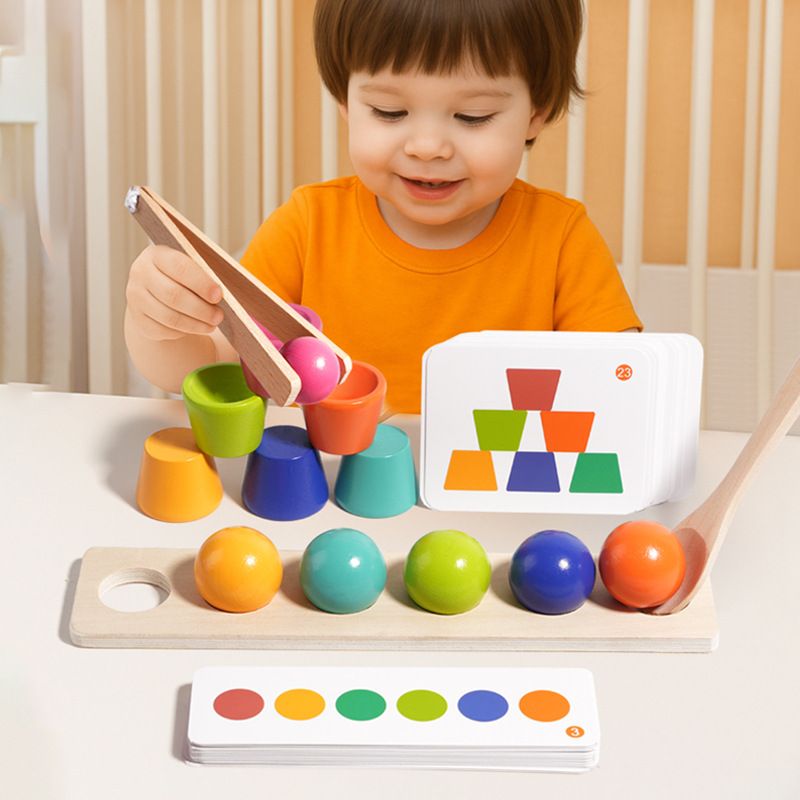 Toddler engaged with colorful Montessori toys, developing fine motor skills and cognitive matching abilities.